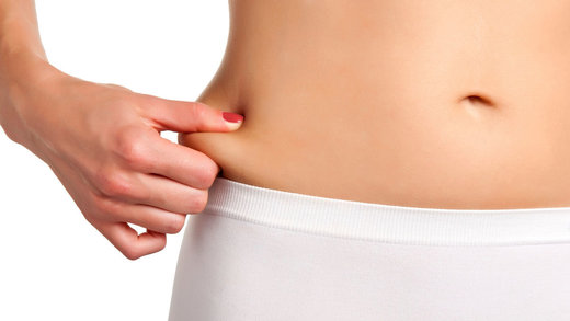 woman pinching stomach belly fat