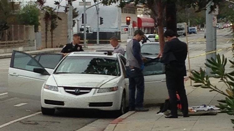 Click to enlarge Police look over the suspect's car in Santa Monica
