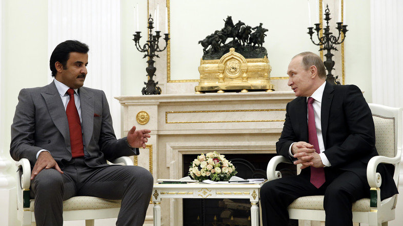 Russian President Vladimir Putin, right, speaks with Qatar's Emir Tamim bin Hamad Al Thani