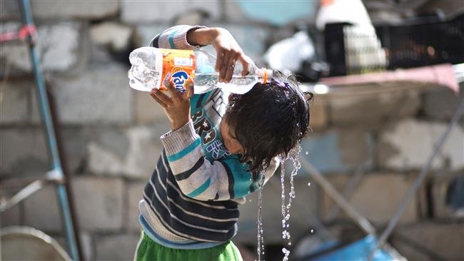 A file photo of a Palestinian child pouring water over his head