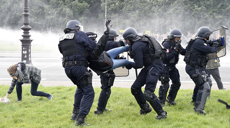 Click to enlarge Police officers detain a demonstrator during clashes near the Invalides during a protest against proposed labour reforms in Paris on June 14, 2016