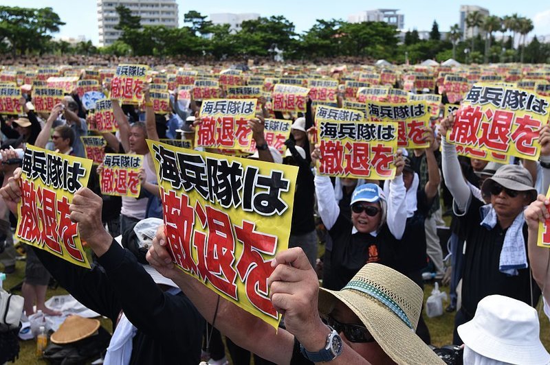 protester signs okinawa japan