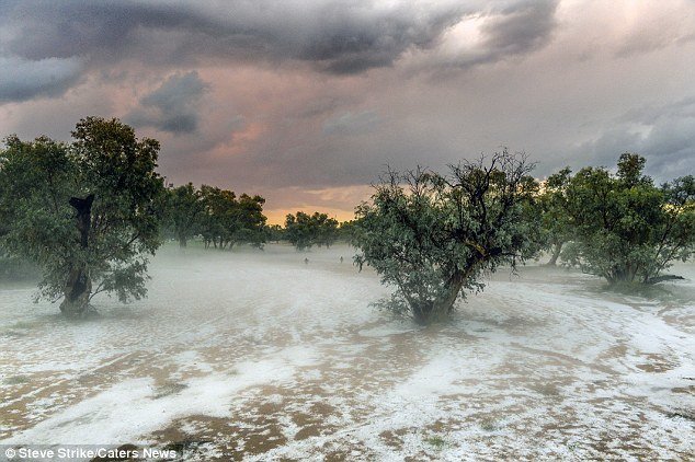 Click to enlarge he water in the Todd River, which is usually dry, was capped with ice and carpeted with fog from the hail