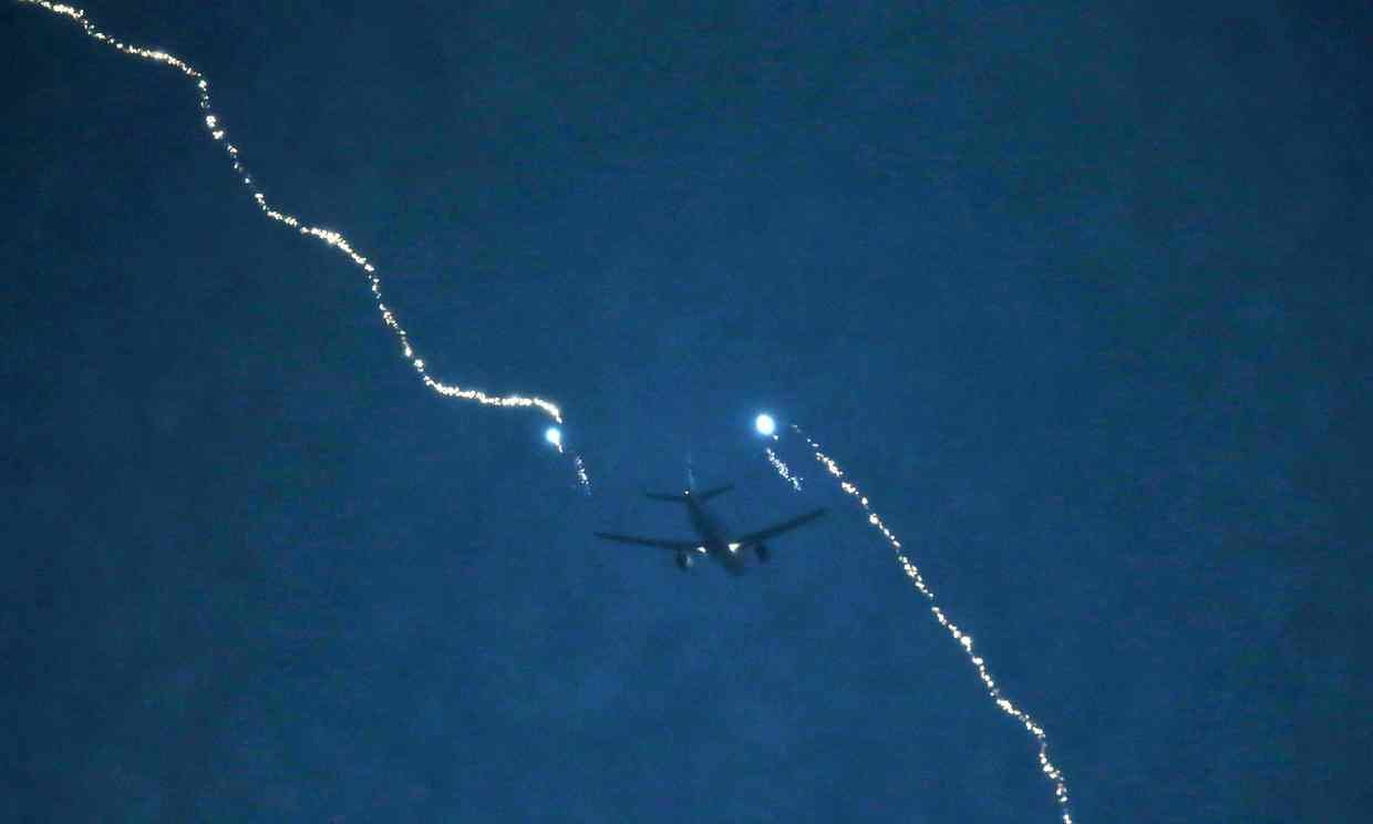 Lightning strikes a plane coming into land at Heathrow Airport on 27 April 2016. 