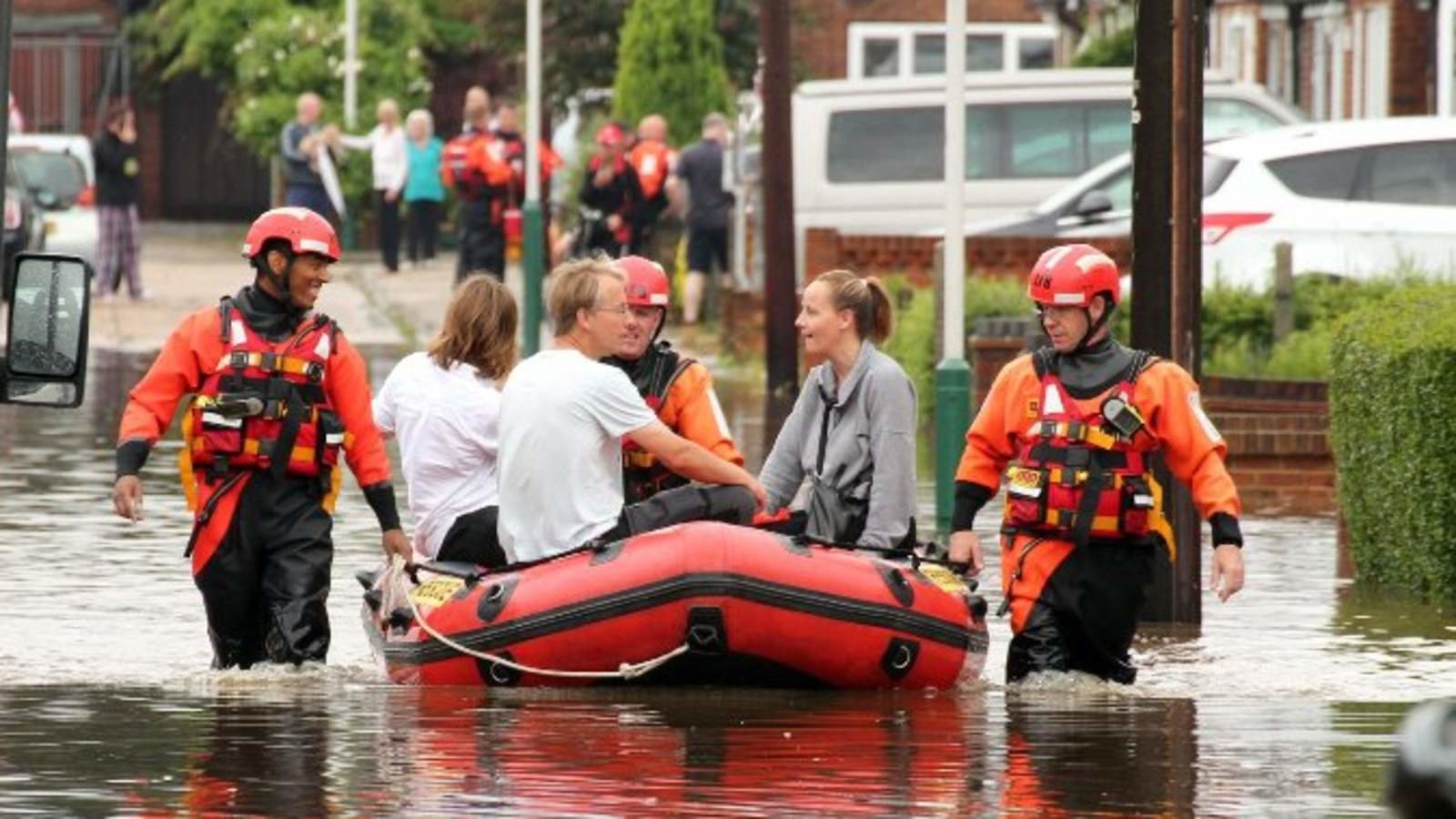 Rescue bid: The firebrigade rescues a family from a flooded street in Romford 