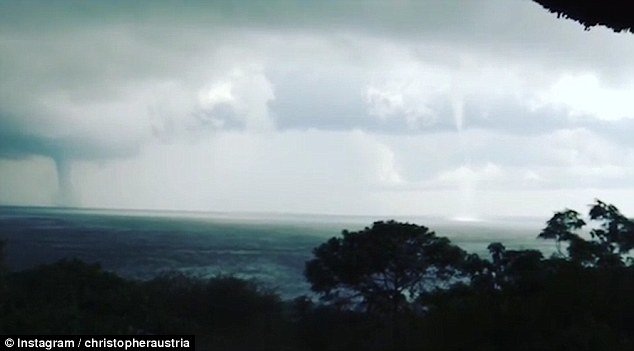 Click to enlarge A wildlife photographer has captured the incredible sight of double waterspouts on Lake Victoria in Uganda