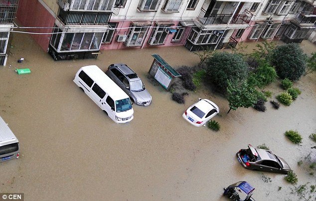 No way out: Cars are left stuck and submerged in water after heavy downpours resulted in flooding