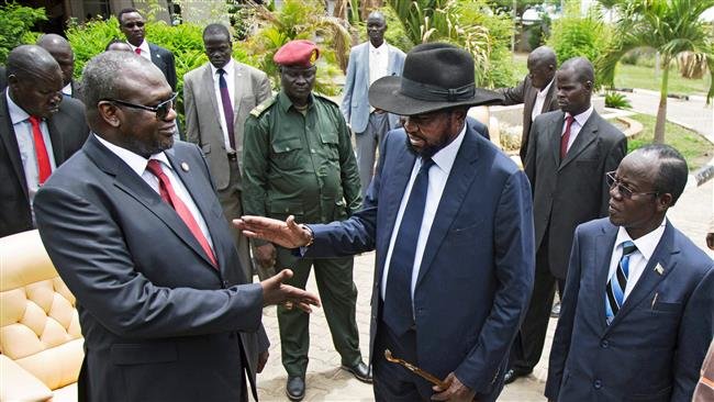 First Vice President of South Sudan and former rebel leader Riek Machar (L) shakes hands with South Sudan President Salva Kiir (C)
