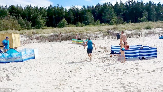 Click to enlarge Incredible footage shows the beast knocking people over their chairs and sand castles before taking down nearby women and children
