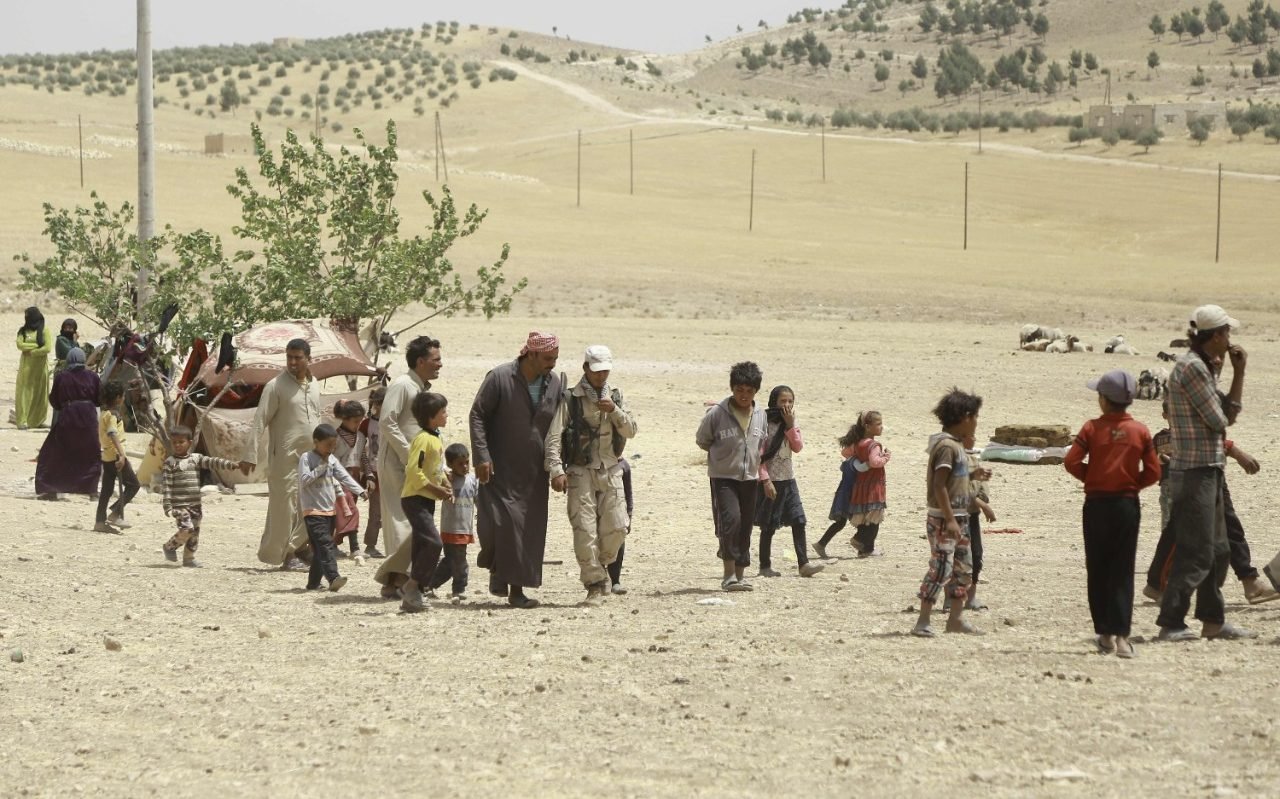 Syrian families, who fled the assault