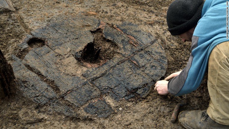 Click to enlarge Archaeologists carefully uncover the 3,000-year-old wheel at England's Must Farm excavation site.