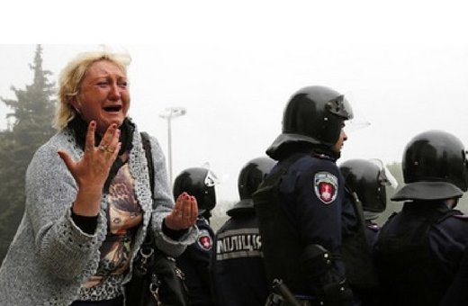 woman reacts outside a trade union building