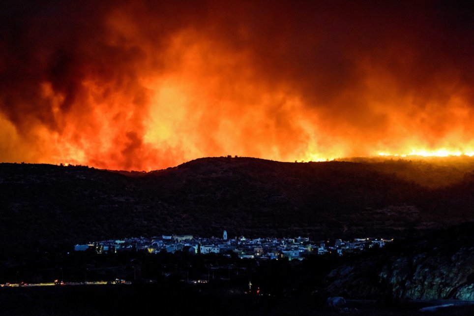 Dense smoke over Lithi village during a wildfire on Chios island, Greece 