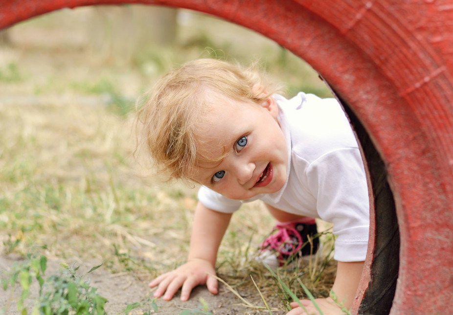 Click to enlarge Child playing in a red tire