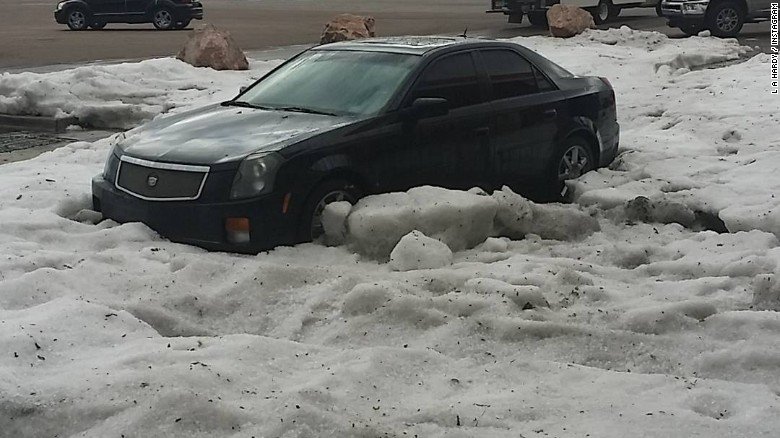 A large mound of ice is blocking a car ten hours after a strong hail storm hit Colorado Springs.
