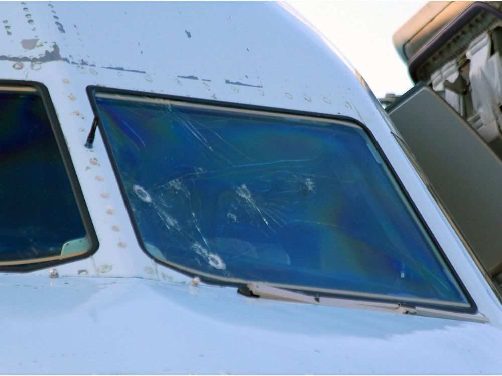 A view of the damaged windshield of Air Canada flight AC1159 after it landed in Lethbridge, Alta., Saturday, July 30, 2016. The plane was diverted from Calgary when the windshield sustained heavy hail damage. No injuries were reported from the 144 passeng