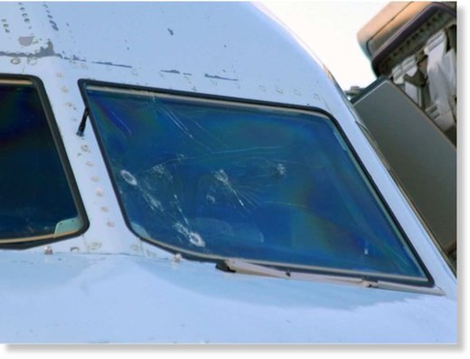 A view of the damaged windshield of Air Canada flight AC1159 after it landed in Lethbridge, Alta., Saturday, July 30, 2016. The plane was diverted from Calgary when the windshield sustained heavy hail damage. No injuries were reported from the 144 passeng