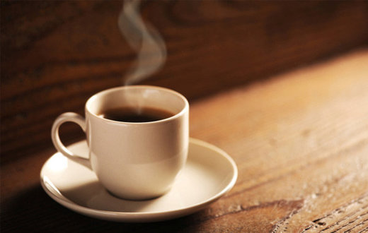 Click to enlarge steaming coffee cup on wood table