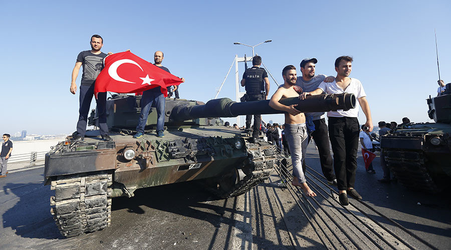 People pose near a tank after troops involved in the coup surrendered on the Bosphorus Bridge in Istanbul, Turkey July 16, 2016