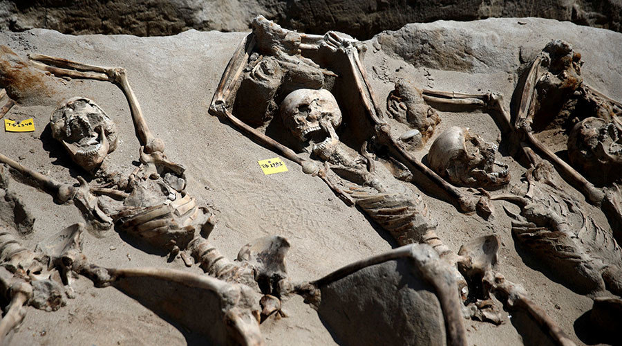 Skeletal remains, with iron shackles on their wrists, are laid in a row at the ancient Falyron Delta cemetery in Athens, Greece