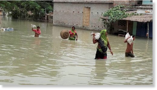 Gopalganj: Villagers move to a safe place from floods in Gopalganj in Bihar on Saturday. 