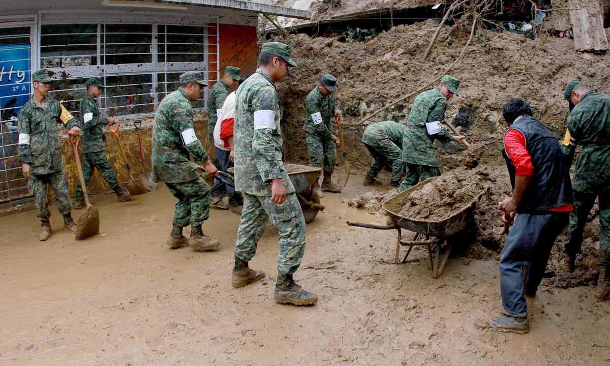 Soldiers help dig out damaged homes in Veracruz, Mexico. Six people died in the state when their homes were buried by landslides. 