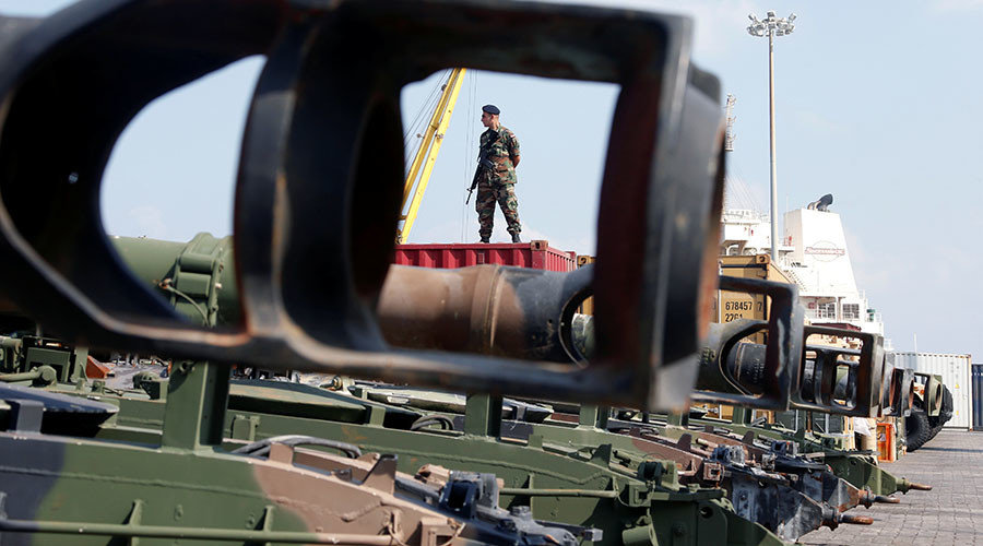 Lebanese Army soldier stands near unloaded Howitzers