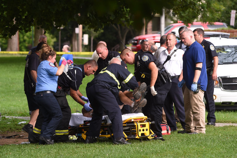 Emergency personnel put a victim onto a stretcher in Mansion Square Park in Poughkeepsie, N.Y., on Friday, after a powerful thunderstorm hit the park.