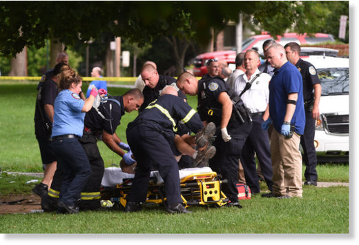 Emergency personnel put a victim onto a stretcher in Mansion Square Park in Poughkeepsie, N.Y., on Friday, after a powerful thunderstorm hit the park.