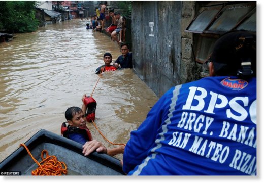 Residents ride on a makeshift boat after evacuating their homes due to the flooding brought on by monsoon rains in San Mateo, Rizal, Philippines. The devastating floods have so far claimed the lives of five people across the country