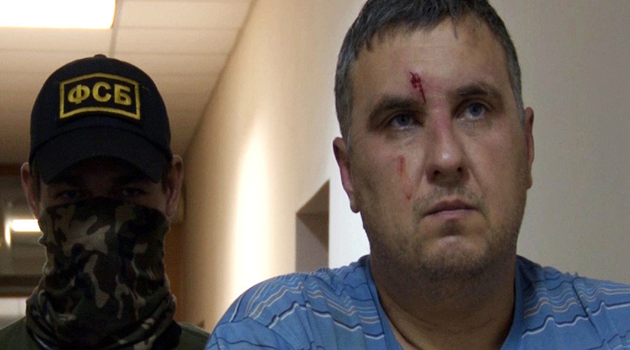 Right: a suspected Ukrainian saboteur detained by the Russian Federal Security Service in Crimea.