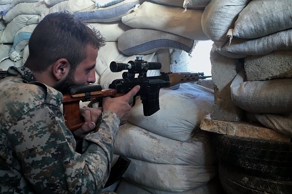 Click to enlarge A Syrian Army soldier in southern Aleppo