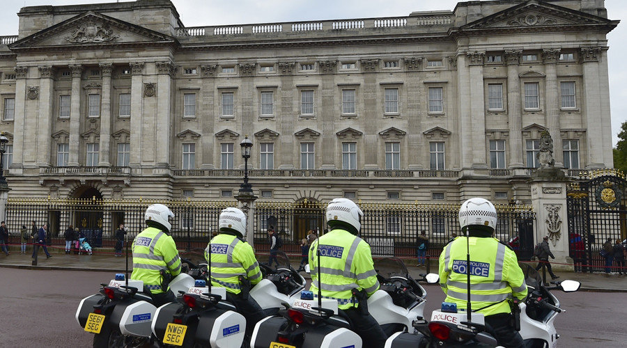 Police motorcycle outriders wait outside Buckingham Palace in central London