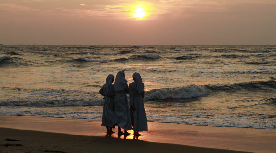 Click to enlarge Nuns on Italian beach sunset