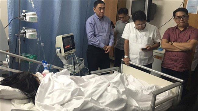 Click to enlarge Philippine Irma Avila Edloy lying in bed