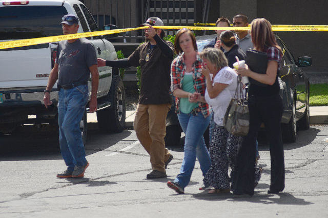 Click to enlarge Homicide detectives escort a crying woman