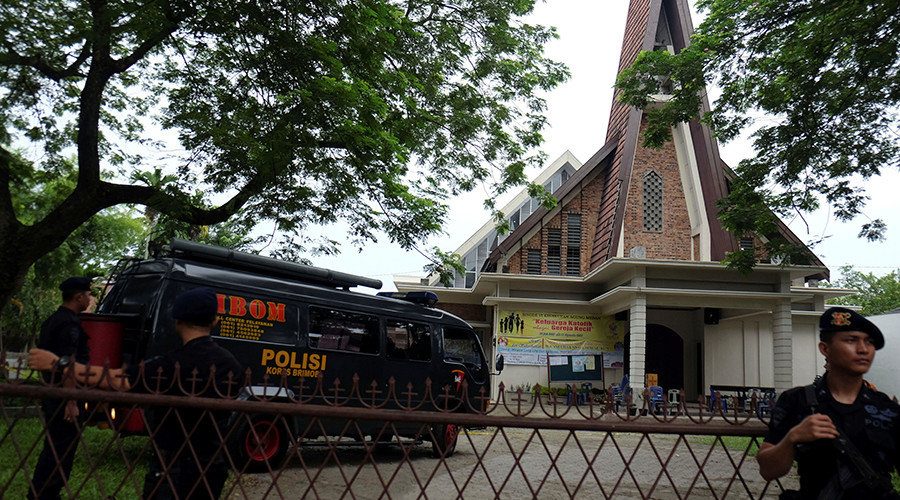 Police are seen outside Saint Joseph catholic church in Indonesia