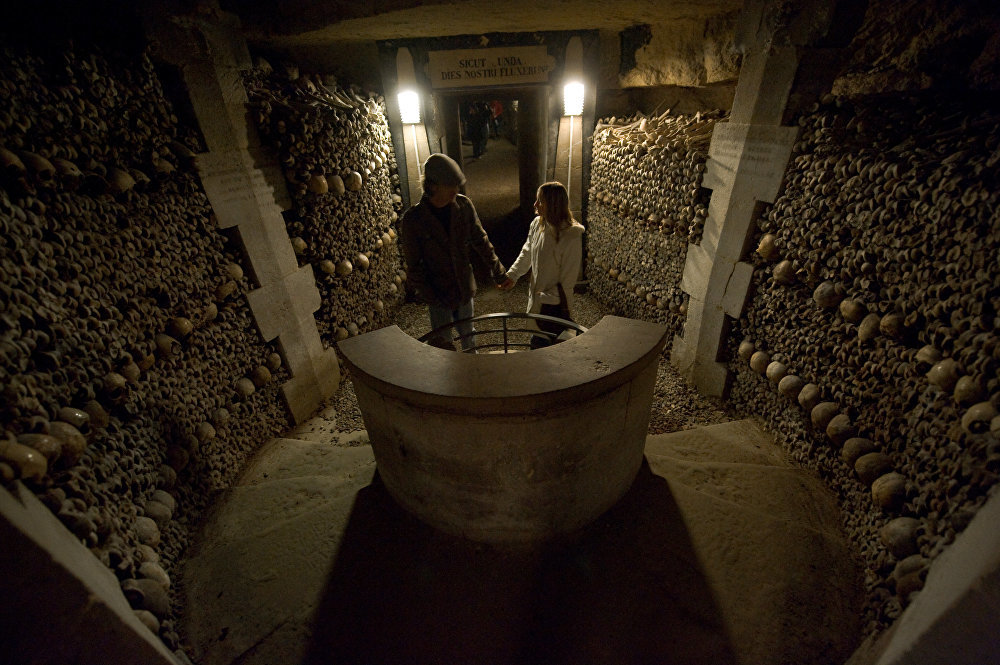 Click to enlarge People visit the section of Paris Catacombs