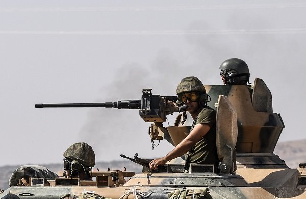 Click to enlarge Turkish soldiers sit on a tank