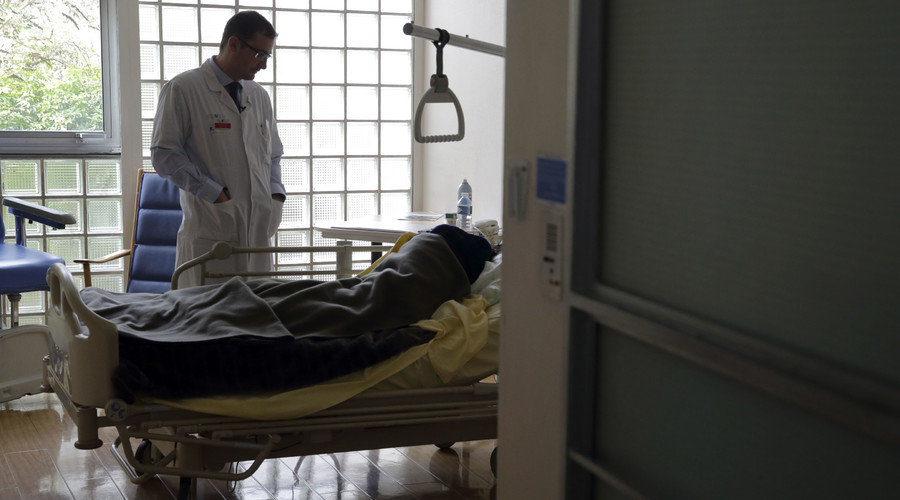 Doctor at hospital bed