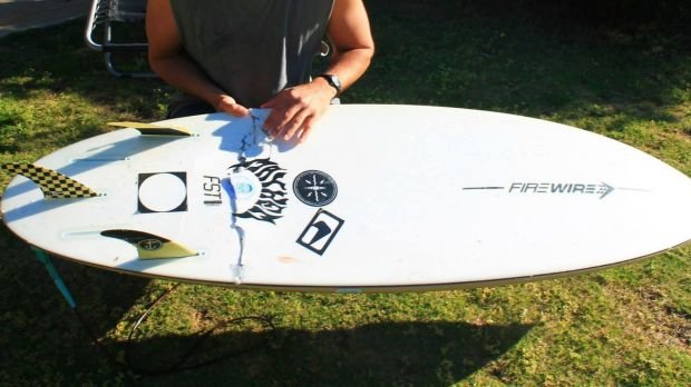 Click to enlarge The board was left ripped following Mr Penman's close call with the shark.