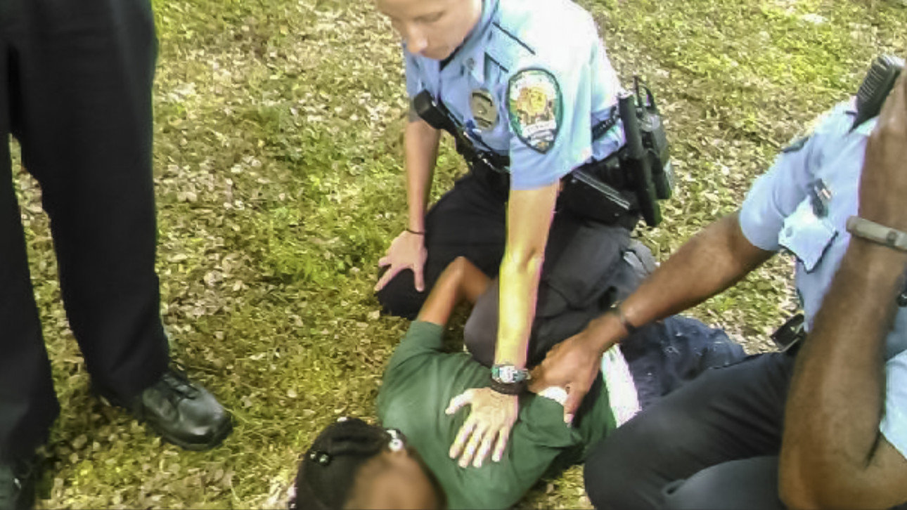Click to enlarge police arresting black child