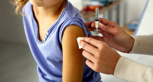 Click to enlarge Small child receives vaccination