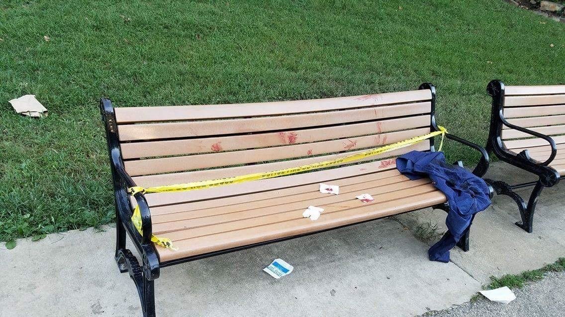 A bench at Wyman Park Dell is blocked by police tape after a 64-year-old man was stabbed