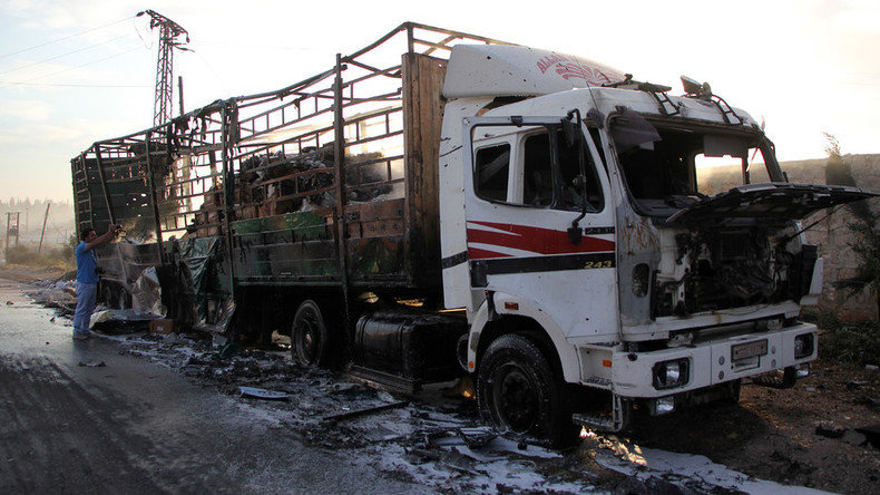 A damaged truck carrying aid is seen on the side of the road in the town of Orum al-Kubra 