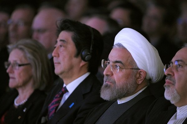 Iranian President Hassan Rouhani (R) sits next to Japanese Prime Minister Shinzo Abe (L)