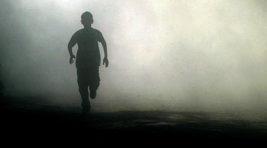 boy running in fog