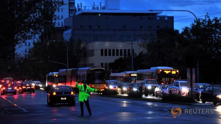 Police direct traffic in the central business district (CBD) of Adelaide after severe storms and thousands of lightning strikes knocked out power to the entire state of South Australia, September 28, 2016. 