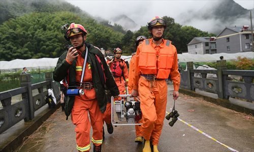 Rescuers arrive at the accident site after a landslide hit Sucun Village of Suichang County, east China's Zhejiang Province, Sept. 29, 2016. 