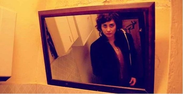 woman looking in mirror